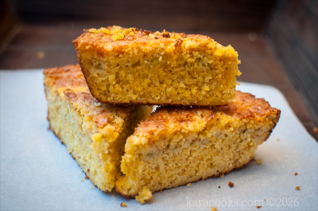 three wedges of southern style cornbread on a sheet of white parchment paper